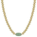 Beaded necklace with a green pendant on a white background