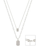 Silver chain necklace with pendant on a white background