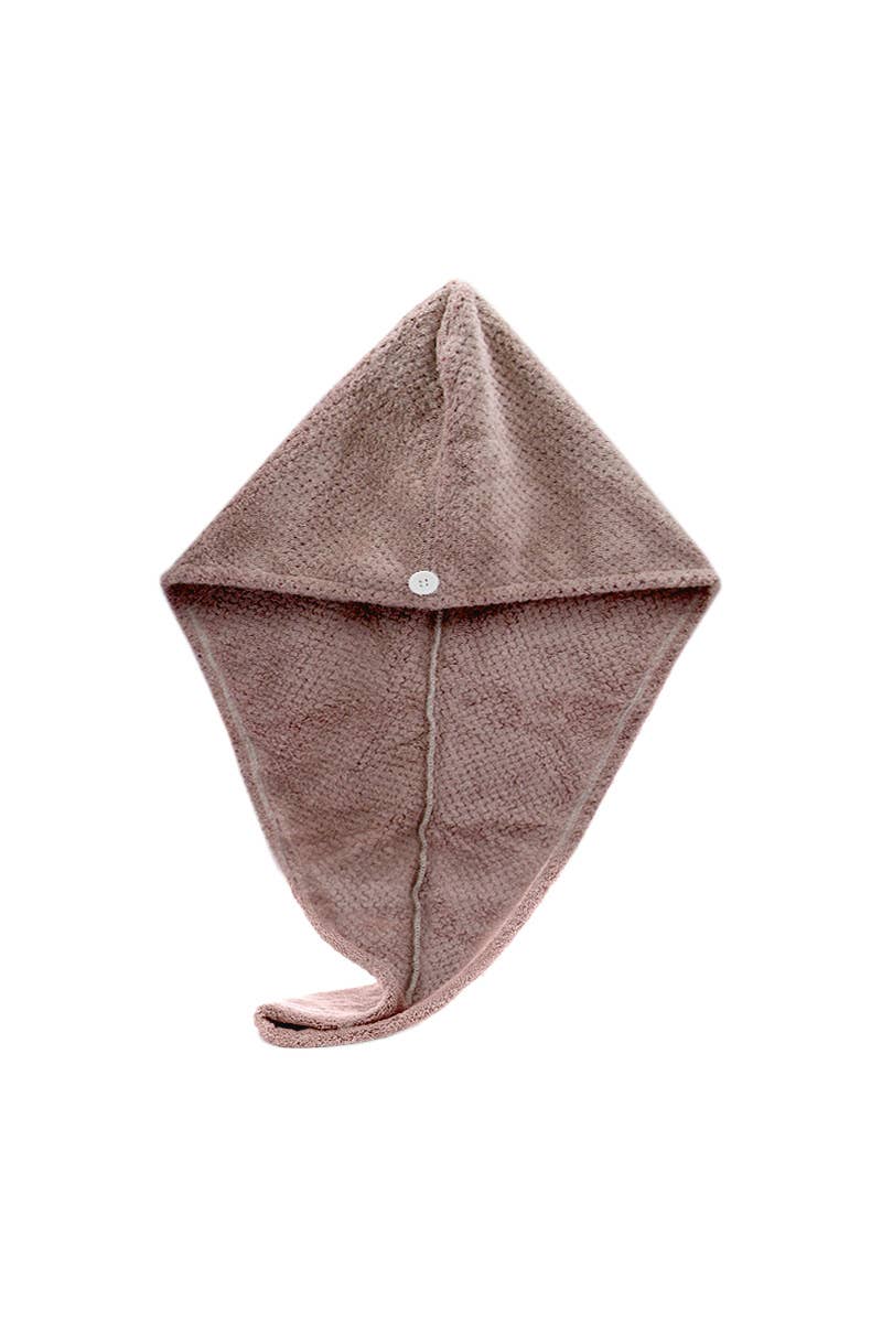 Pink knitted baby hat on a white background