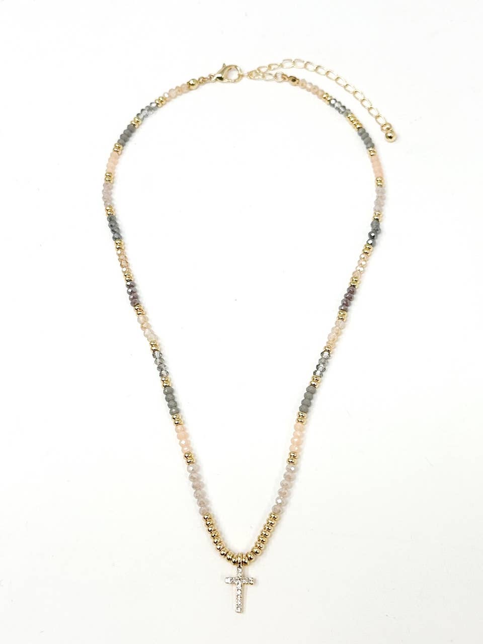 Necklace with multicolored beads and a cross pendant on a white background