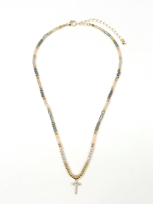 Necklace with multicolored beads and a cross pendant on a white background