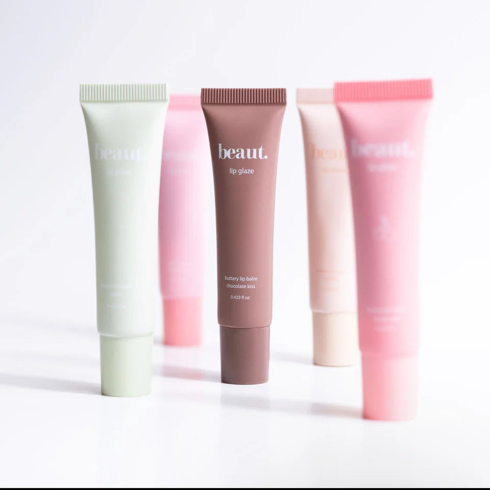 Five tubes of 'beaut.' lip glaze in different colors on a white background