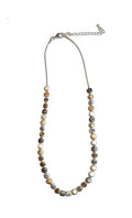 Necklace with multicolored beads on a white background