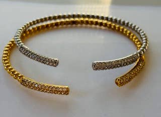 Gold and silver bracelet on a white background
