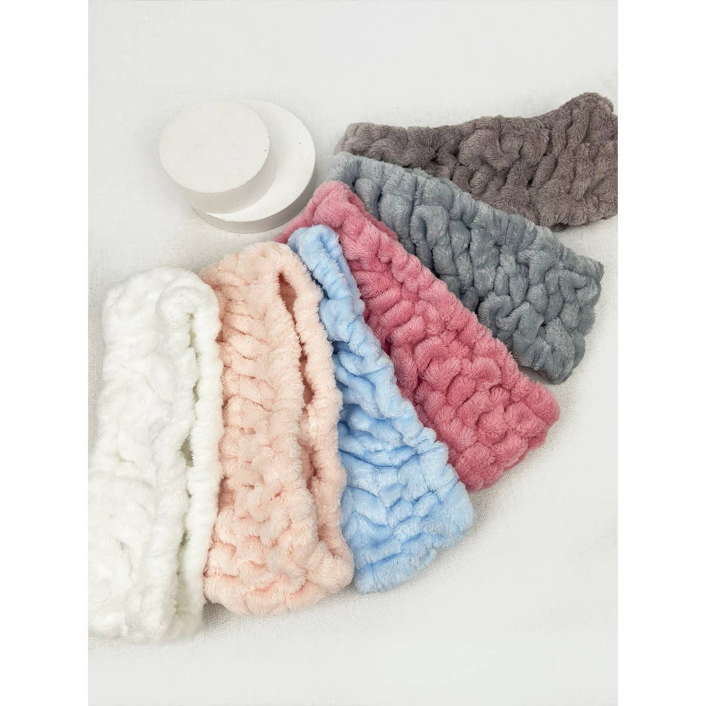 Set of colorful knitted headbands on a white background
