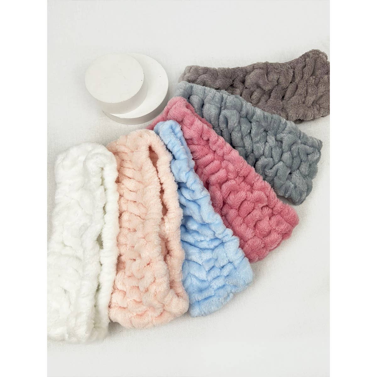 Set of colorful knitted headbands on a white background