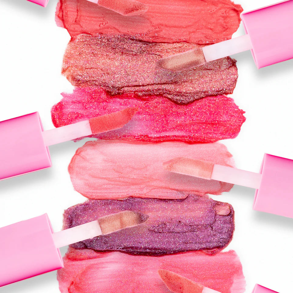 Collection of pink lip gloss shades on a white background