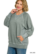 Woman wearing a gray sweatshirt with white accents on a white background