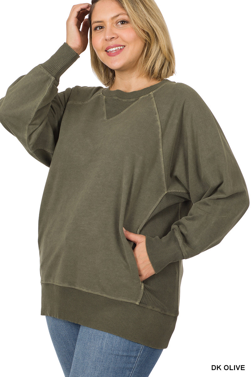 Woman wearing a dark olive green sweatshirt on a white background