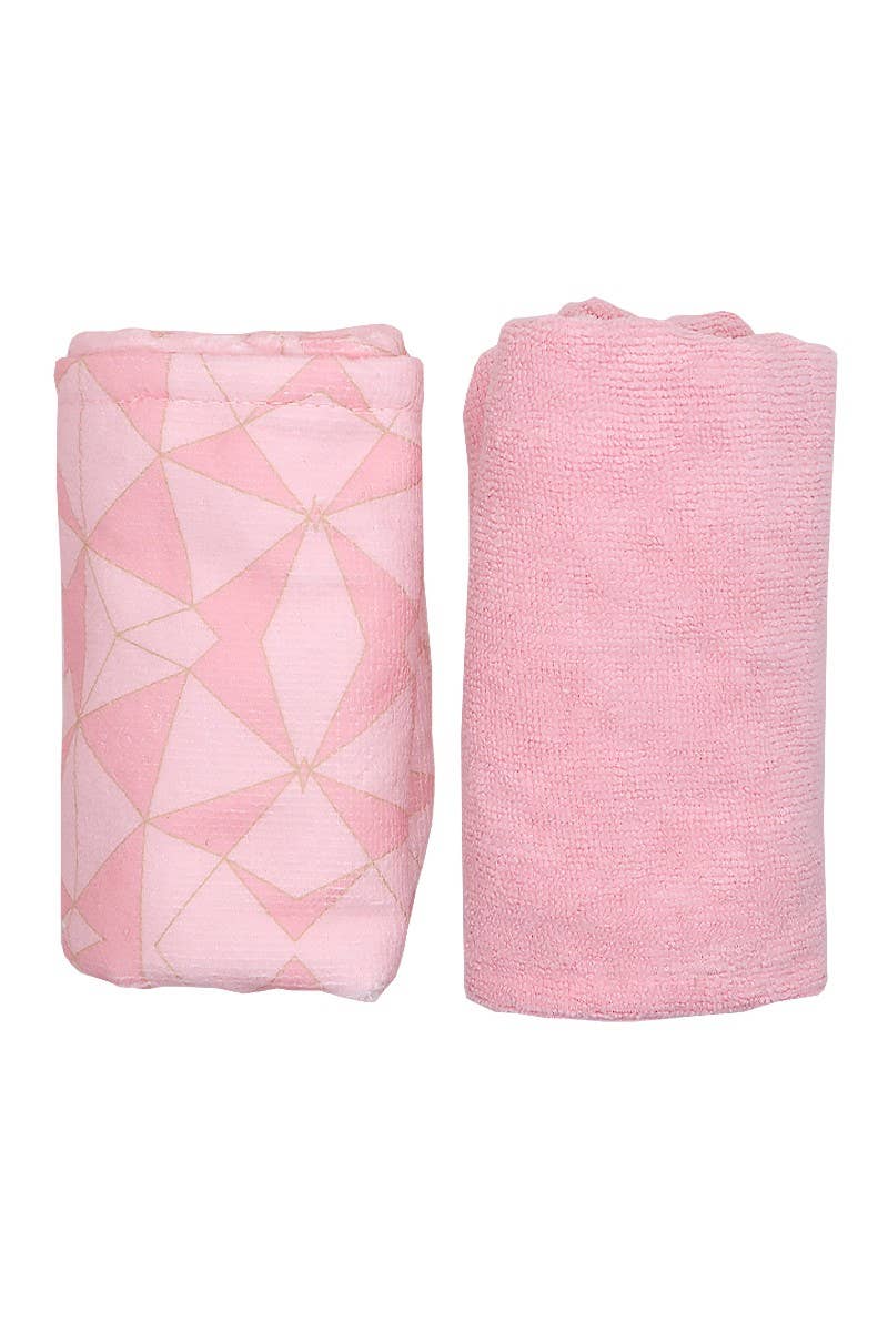 Two pink baby blankets, one with a geometric pattern and the other plain, on a white background.