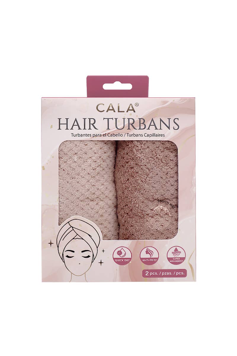 Packaging of Cala hair turbans with two turban designs on a white background