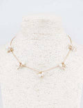 Delicate necklace on a mannequin with a light gray background
